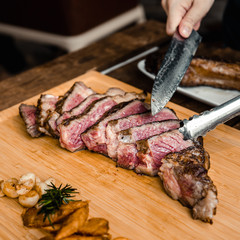 Cutting Grilled Australian Tomahawk Steak