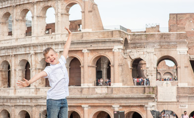 Very happy boy near coliseum in Rome, Italy. Travel concept. Empty space for text