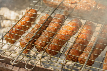 cevapcici on the grill are roasted on an open fire. Summer barbecue weekend. Shashlik is a national Caucasian dish