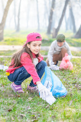 Group of children pick up trash in the park. Volunteer and ecology concept