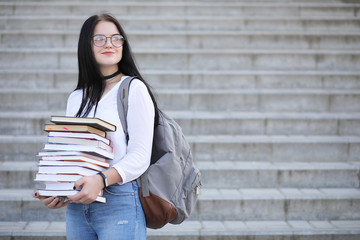 Girl student on the street with books