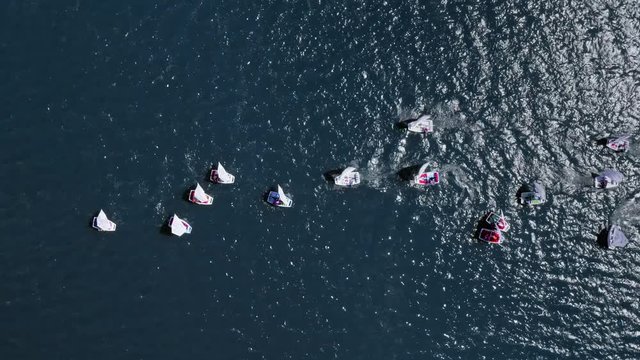 Regatta of small boats on the lake in summer