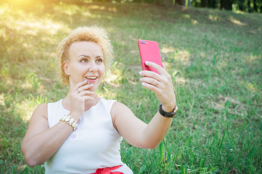 Woman taking selfie on smart phone in the street