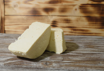 Beautiful, healthy and tasty feta cheese on a beautiful textured wooden background