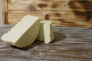 Beautiful, healthy and tasty feta cheese on a beautiful textured wooden background