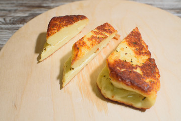 Delicious, fried and healthy Halloumi cheese on a light wooden tray on a beautiful wooden background