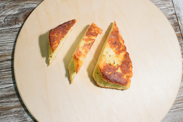 Delicious, fried and healthy Halloumi cheese on a light wooden tray on a beautiful wooden background
