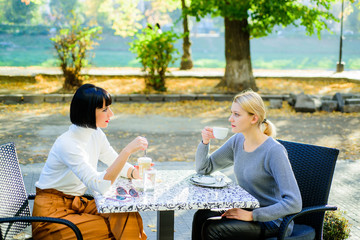 Friendship meeting. Togetherness and female friendship. Conversation of two women cafe terrace. True friendship friendly close relations. Trust her. Girls friends drink coffee and enjoy talk