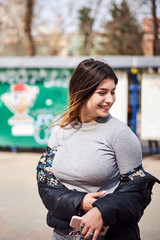 Young caucasian girl with futuristic earphones and streak hair