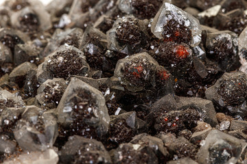 Macro of a stone Ilvaite mineral on a white background