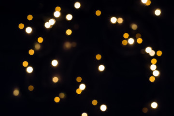 Falling hexagonal bokeh lights on black. Holiday concept