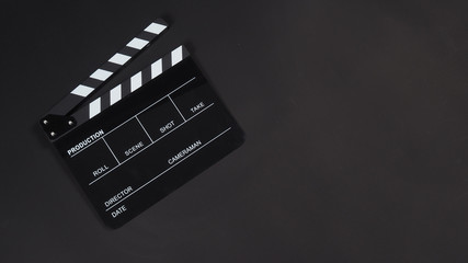 Fototapeta na wymiar Black Clapperboard or clap board or movie slate use in video production ,film, cinema industry on black background.