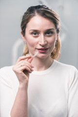 Young caucasian female dentist at the workplace in a dentistry cabinet