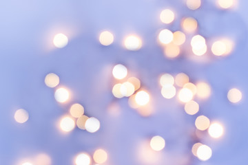 Obraz premium Golden festive bokeh lights on blue background. Christmas or party concept