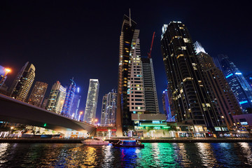 Obraz na płótnie Canvas Dubai Marina at night with colorful touristic boats
