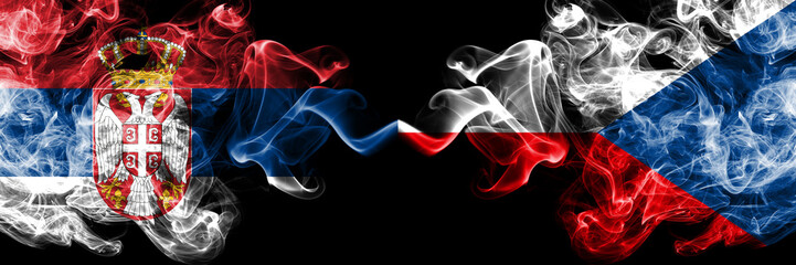 Serbia vs Czech Republic smoky mystic flags placed side by side. Thick colored silky smokes combination of Serbian and Czech Republic flag