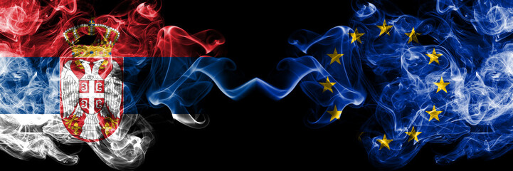 Serbia vs European Union, EU smoky mystic flags placed side by side. Thick colored silky smokes combination of Serbian and European Union, EU flag