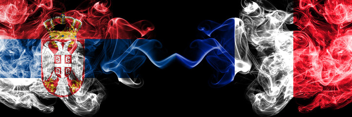 Serbia vs France, French smoky mystic flags placed side by side. Thick colored silky smokes combination of Serbian and France, French flag