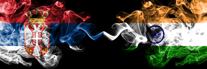 Serbia vs India, Indian smoky mystic flags placed side by side. Thick colored silky smokes combination of Serbian and India, Indian flag
