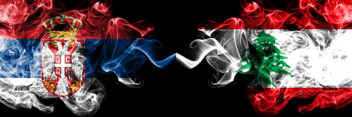 Serbia vs Lebanon, Lebanese smoky mystic flags placed side by side. Thick colored silky smokes combination of Serbian and Lebanon, Lebanese flag