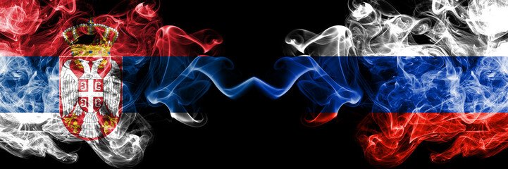 Serbia vs Russia, Russian smoky mystic flags placed side by side. Thick colored silky smokes combination of Serbian and Russia, Russian flag