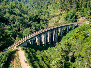 Fototapeta na wymiar Aerial of famous nine arch bridge in Ella, Sri Lanka with blue train
