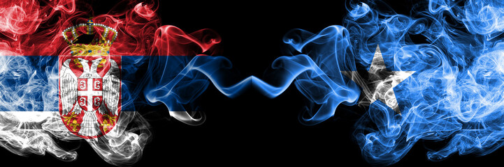 Serbia vs Somalia, Somalian smoky mystic flags placed side by side. Thick colored silky smokes combination of Serbian and Somalia, Somalian flag
