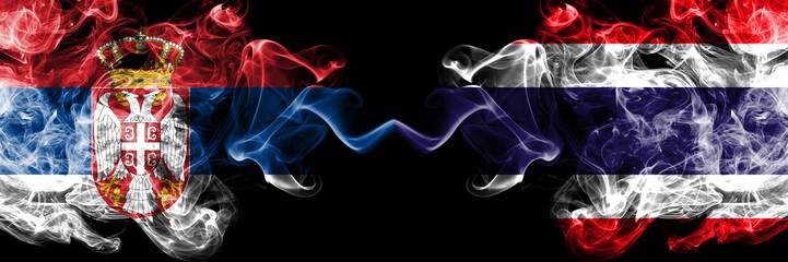 Serbia vs Thailand, Thai smoky mystic flags placed side by side. Thick colored silky smokes combination of Serbian and Thailand, Thai flag