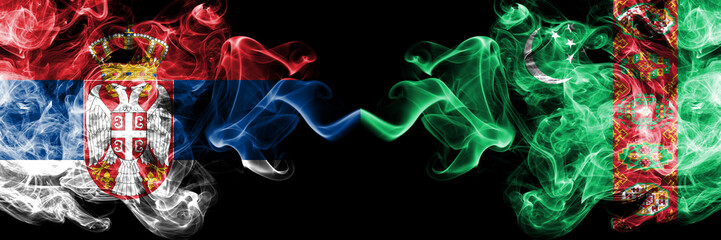 Serbia vs Turkmenistan, Turkmenistans smoky mystic flags placed side by side. Thick colored silky smokes combination of Serbian and Turkmenistan, Turkmenistans flag
