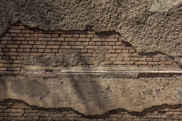 brick wall with broken down plaster