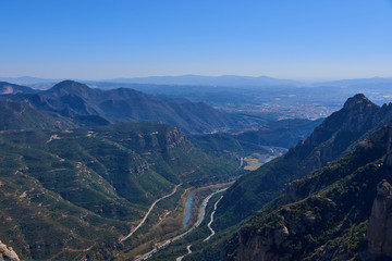 Fototapeta premium Top view of the river and the road passing between the mountains.