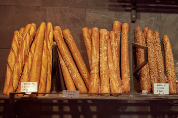 Long loaves of freshly baked bread on the shelf in the store