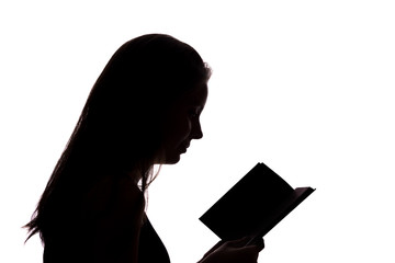 Silhouette of a girl with a book
