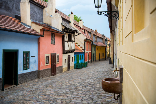 Cobblestone street and colorful 16th century cottages of artisans known as Golden Lane inside the castle walls Prague Czech Re