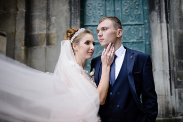 Wedding couple hugging on the background of the old church