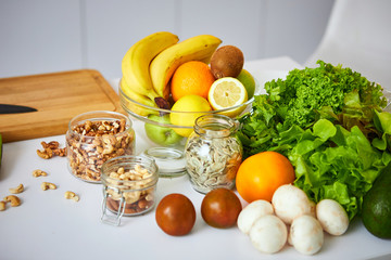 Raw organic vegetables, fruits and nuts with fresh ingredients for healthily cooking on kitchen. Vegan or diet food concept. Healthy Lifestyle and Eating