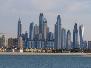 View of the artificial island of Palm Jumeirah and the skyscrapers of Dubai from the beach of Aquaventure water park,