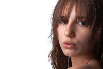 Close-up shot of a young caucasian girl with curly hair and bangs