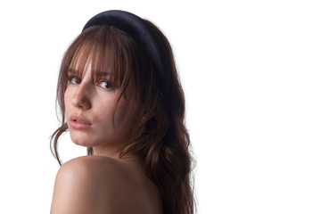 Fototapeta premium Close-up shot of a young caucasian girl with curly hair and bangs