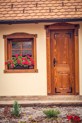 Old brown wooden window with flowers and wooden doors,.