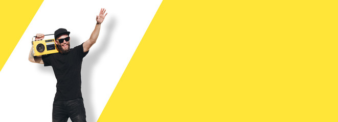 Man in black clothe listen to retro tape recorder and waving to the crowd