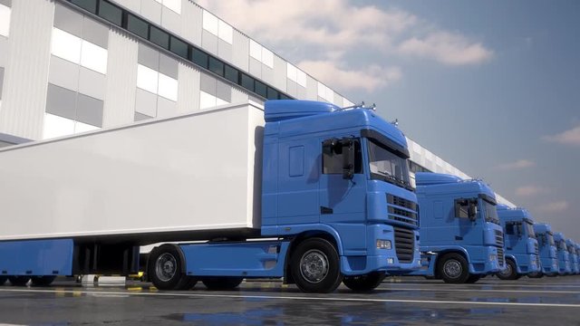 Endless row of blue semi trucks loading and unloading goods at warehouse dock. Parallel tracking shot. Seamless loop. Realistic high quality 3d animation.
