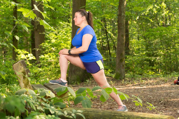 Lady stretches as part of her exercise routine