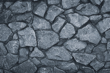 Fototapeta premium Gray stone wall texture. Grey rock pattern. Grunge rocky road. Granite textured, urban architecture. Surface of masonry background.