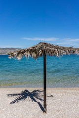 Salamina, Greek island. Beautiful view of the sea, beach and umbrella.