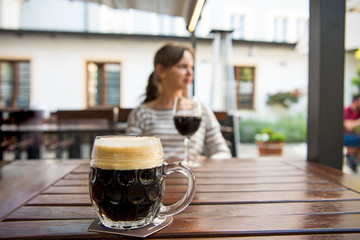 Young beautiful girl on the background of a glass of beer.