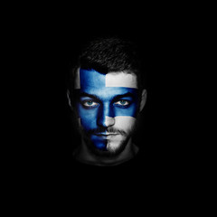 Flag of Finland painted on a face of a man on black background.