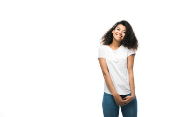 cheerful african american girl in white t-shirt standing isolated on white