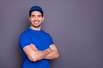 Close up side profile photo express specialist he him his strong arms crossed beaming smile self-confident person order offer customer wear blue t-shirt cap corporate suit isolated grey background