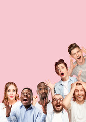 Fototapeta premium Collage of close up portraits of 7 young people on coral pink background. The human emotions, facial expression concept. Celebrating, wondering, feeling like a winners, astonished and shocked.